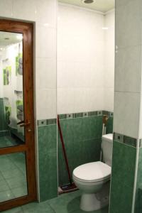 a bathroom with a toilet and a glass shower at Rent House in Yerevan