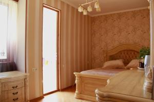 a bedroom with a wooden bed and a window at Rent House in Yerevan