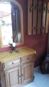a wooden dresser with a mirror on a wall at Mama Sofia's house 