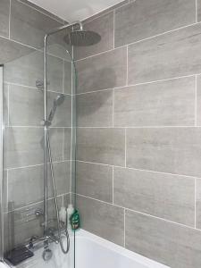 La salle de bains est pourvue d'une douche avec un pommeau de douche. dans l'établissement Huntingdon Luxury Apartments, à Huntingdon