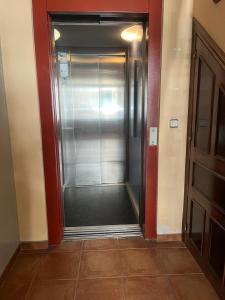 a hallway with a metal elevator in a building at Vivienda Turística LA TRINIDAD in Úbeda