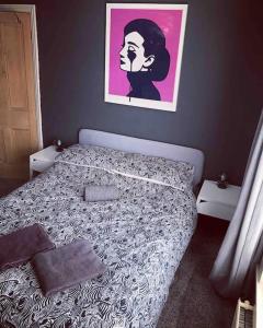 a bedroom with a bed with a picture on the wall at Chester/Handbridge sleeps 6 with BT Sports & Pac-man in Hough Green