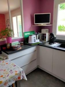 a kitchen with pink walls and a counter top at House with garden in Biarritz - quiet area in Biarritz