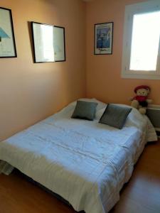 a bedroom with a large bed with two pillows at House with garden in Biarritz - quiet area in Biarritz