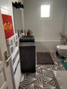 a bathroom with a black sink and a tub at House with garden in Biarritz - quiet area in Biarritz