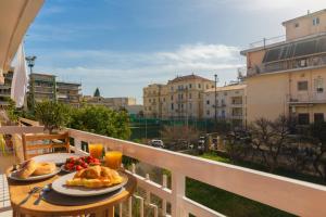 a table with two plates of food on a balcony at Luxury Ap.Tennis in Ágios Rókkos