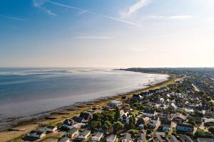 an aerial view of a beach with houses and the water at Vista Caravan Hire in Seasalter