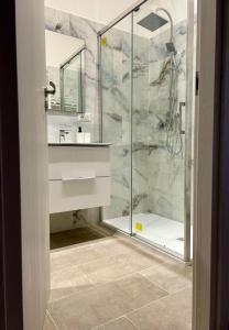 a bathroom with a glass shower with a sink at Palmira's Rome Sweet Home in Rome
