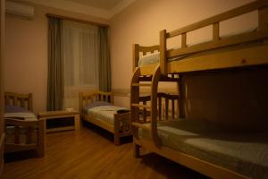 a room with two bunk beds and a window at Guesthouse Hillside in Tbilisi City