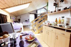 a kitchen with a table with a plate of food on it at Pension Merbald in Beilngries