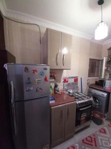 a kitchen with a stainless steel refrigerator and a stove at Stunning Sea View Flat (One Bed Room)Entire Place in Alexandria