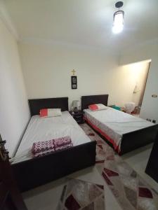 a room with two beds in a room at Stunning Sea View Flat (One Bed Room)Entire Place in Alexandria