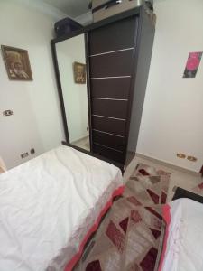 a bedroom with a large mirror and a bed at Stunning Sea View Flat (One Bed Room)Entire Place in Alexandria +11 photos