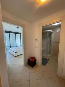 a room with a bathroom with a shower and a bed at San Lorenzo Marina Apartment in San Lorenzo al Mare