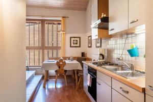 a kitchen with a table and a dining room at Moserhof Ferienwohnung Schartblick in Sarntal