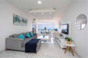 a living room with a couch and a table at 24 Sea Lodge - Sea Viewing Apartment in Durban