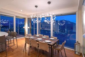 a dining room with a table and chairs and a large window at Executive Penthouse Como Condo sleeps 5 by Italian Apartments in Como