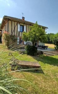 a house with a picnic table in front of it at Maison dans le sud du Gers 