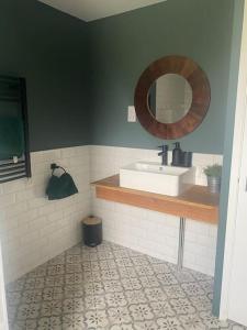 a bathroom with a sink and a mirror at The Old Nurseries Luxury Guest Suite in Lincolnshire