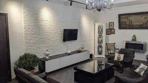 a living room with a white brick wall at Tirkius House in K'obulet'i