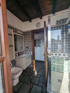 a bathroom with a toilet and a sink and a shower at Borgo Dora House in Turin