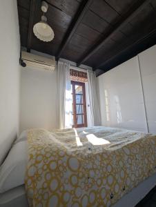 a bedroom with a bed and a window at Borgo Dora House in Turin