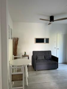a living room with a couch and a table at Apartamentos Cana Sofía in Cala Llonga