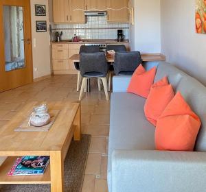 a living room with a couch and a table at Villa Böck am Strand FeWo 8 in Glowe