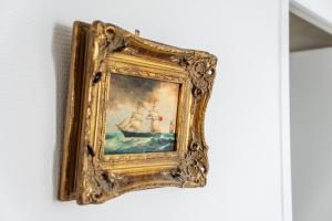 a painting of a ship in the water at Appartement Mozart in Strasbourg
