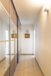 a hallway with white walls and a tile floor at Appartement Mozart in Strasbourg
