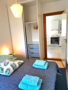 a room with a bed with blue towels on it at Ama Hyg Atelier Copenhagen-Cosy apt-in Copenhagen-near Airport- metro-beach in Copenhagen