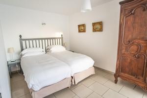 a bedroom with two beds and a wooden cabinet at Appartement Mozart in Strasbourg +45 photos