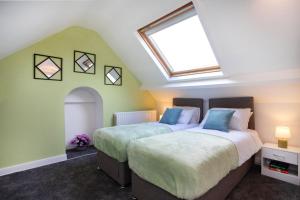 two beds in a attic bedroom with a skylight at * Parking * Smart TV * Sleeps up to 7 * Fast Wi-FI in Lincolnshire