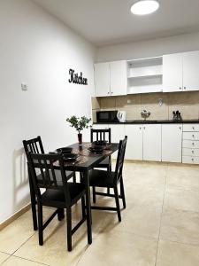 a dining room table and chairs in a kitchen at Spat Vip Apartment in Bat Yam