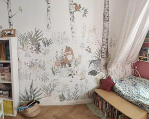 a childs bedroom with a woodland wallpaper at Maison Dolce Vita in Rome