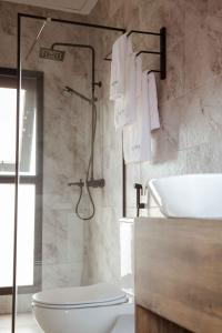 a bathroom with a toilet and a sink at Saphir Boutique Hotel in Kigali