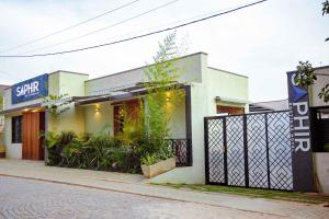 a building with a gate on the side of a street at Saphir Boutique Hotel in Kigali