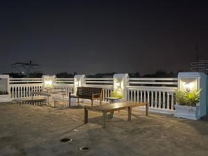 a patio with benches and lights at night at Mulia Homestay in Banda Aceh
