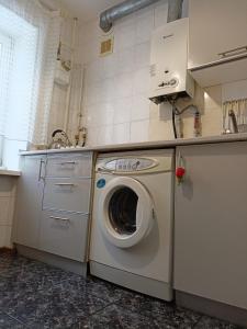 a kitchen with a washing machine and a sink at Apartment Chernihivska 13 in Shostka