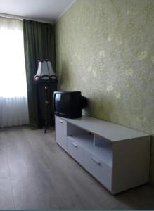 a living room with a tv on a dresser at Apartment Chernihivska 13 in Shostka
