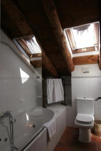 a bathroom with a toilet and a bath tub at Posada el Zaguan in Turégano