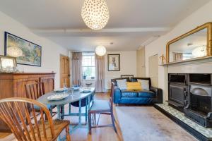 a living room with a table and a couch at Music School Cottage 1 in Oundle