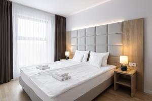 Łóżko lub łóżka w pokoju w obiekcie Green Apartments