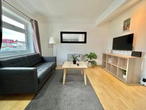 a living room with a couch and a table at No2326 Tree-Hole in Northolt
