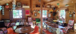a room with wooden walls and tables and chairs at Kyyjärvi Camping And Hotels Oy in Kotkaniemi