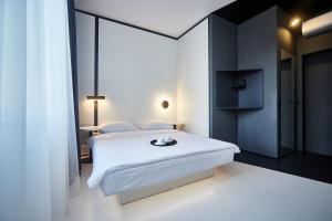 a bedroom with a bed with a white bedspread at Sunday Hotel in Odesa