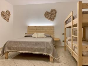 a bedroom with a bed with hearts on the wall at Agriturismo Nonno Mario in Fossone dʼAdige