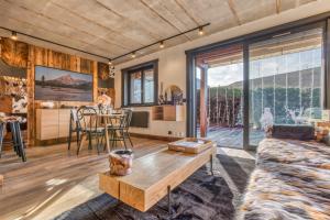 a living room with a couch and a table at Le petit cœur de Megève -Mont770- in Megève