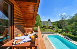 a table with food and drinks next to a swimming pool at Nice home in Sisak with Outdoor swimming pool, WiFi and Heated swimming pool in Sisak