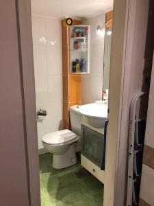 a bathroom with a toilet and a sink at Sea Sunset Appartment in Nea Iraklia
